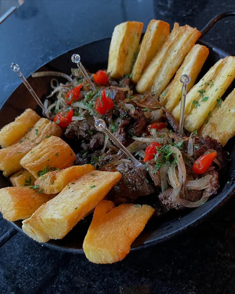 Filé mignon com fritas caseiras servido numa frigideira de ferro